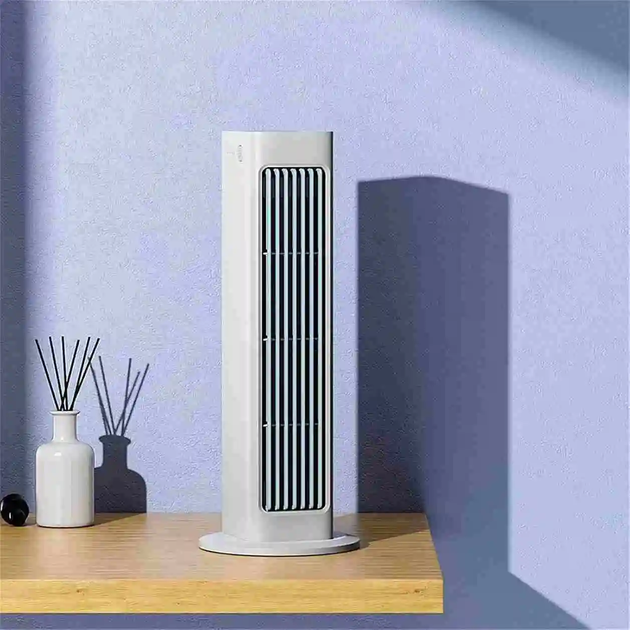 Qinux BreezaMax Slim Tower on a Table in purple background